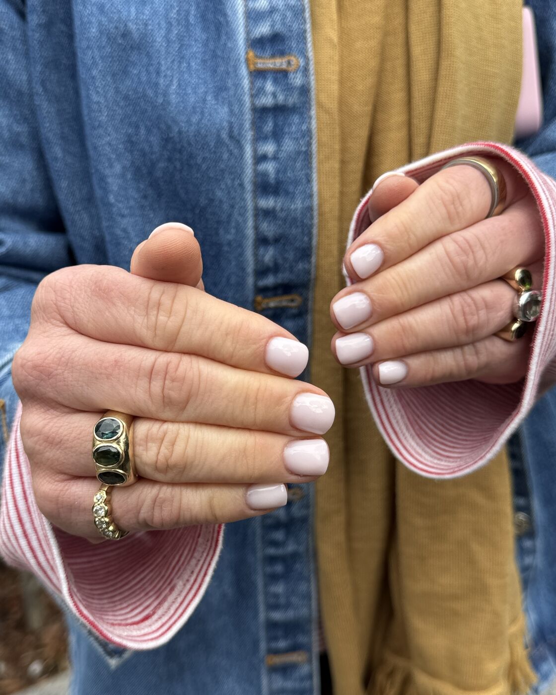 Close-up of hands with a soft nude manicure
